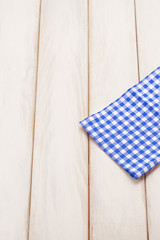 Plaid cloth on picnic table/Wooden picnic table background.