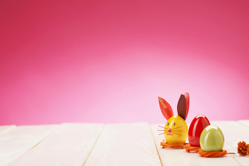 Easter decorative eggs/Decorative eggs on picnic table. Pink background
