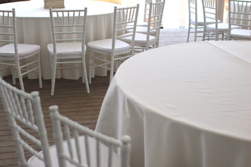 white chairs, white tablecloths on the tables in the restaurant