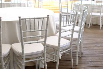 white chairs, white tablecloths on the tables in the restaurant