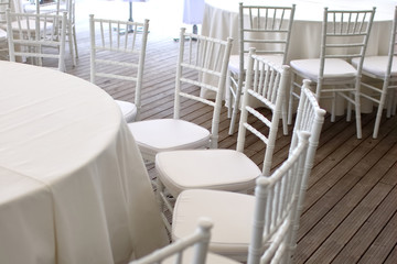 white chairs, white tablecloths on the tables in the restaurant
