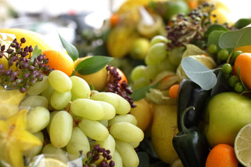 bouquet of fruits: apples, grapes, lemon, lime tangerine, melon, physalis, apricot