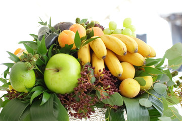 bouquet of fruits: apples, grapes, lemon, lime tangerine, melon, physalis, apricot