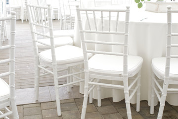 white chairs, white tablecloths on the tables in the restaurant