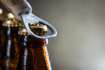 Fotobehang Brown ice cold beer bottles with old opener © Room 76 Photography