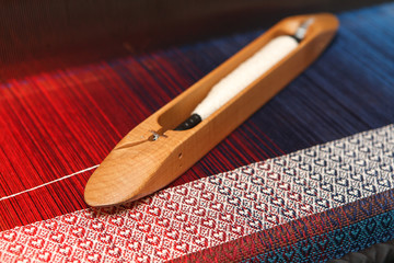 Weaving shuttle on the warp