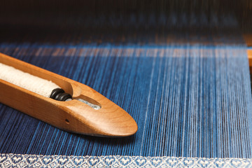 Weaving shuttle on the warp