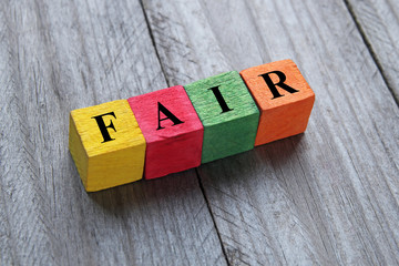 word fair on colorful wooden cubes