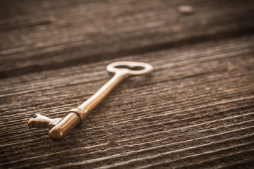 Old Brass Skeleton Key on Dark Rustic Barnwood
