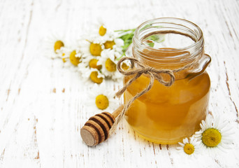 Jar of honey with camomile