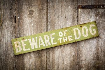 Beware Of Dog Sign on Old Worn Wood Fence