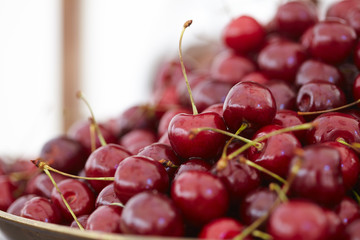 dish with fresh cherries closeup