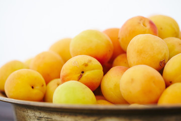 dish with fresh apricots close-up