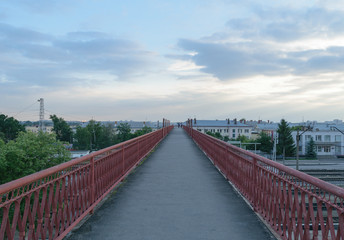 Fototapeta premium Tall and long pedestrian bridge over the railroad tracks
