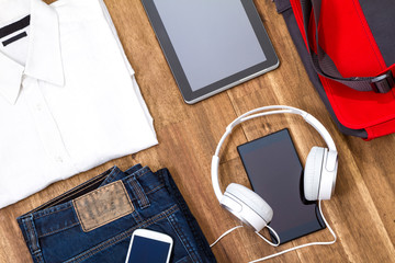 Informal outfit and electronics.