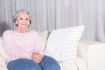 active female senior relaxing on couch