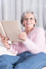 active female senior relaxing on couch