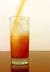Jjuice pouring in glass taken closeup.