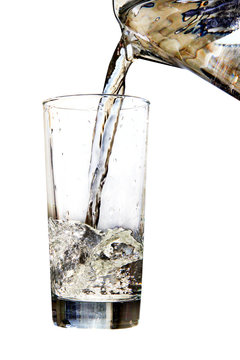 Water jug pouring to glass on white background
