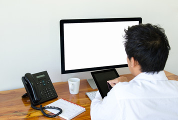 Man use tablet and computer in the office.