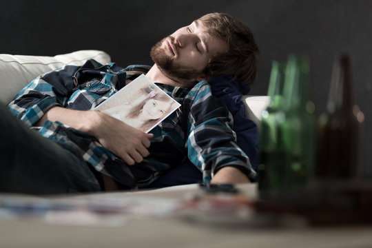 Drunk man lying on couch
