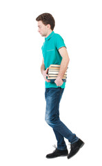 Back view of going  handsome man carries a stack of books.