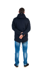 Fototapeta premium Back view of handsome man in winter jacket looking up.