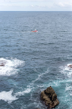 fishing boat along the wild coast of a brittany island