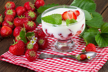 Strawberries dessert with fresh fruits on red checkered napkin