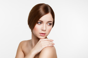 Young beautiful brunette woman with natural makeup on grey backg