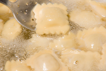 the dumplings cooks in a pan with the boiling water