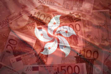 colorful waving hong kong flag on a euro money background