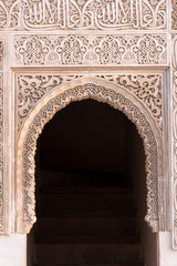 Moorish arch with Arabian script in Alhambra, Granada, Spain