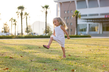 little girl fun rides and jumps on the lawn