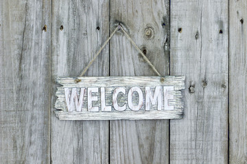 Rustic welcome sign hanging on wood background © laurha