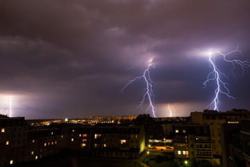 Naklejka na ściany i meble Lightning storm over city.