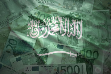 colorful waving saudi arabia flag on a euro money background