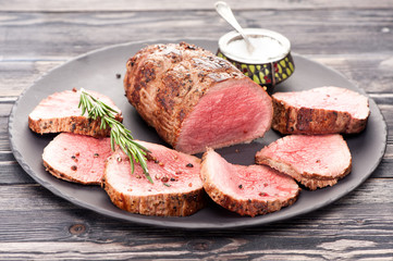 Roast beef with rosemary on a plate