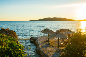 Sunrise on a beautiful beach with sunshade