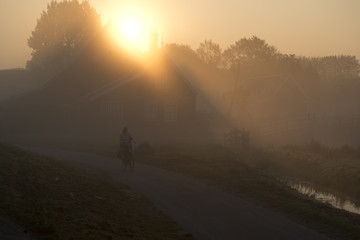 biking trough Zaanse Schans The Netherlands in sunrise