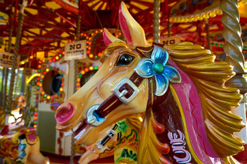 Fototapeta na wymiar Head of a vintage horse of amusement ride on merry-go-round car
