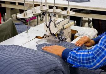 Tailors working in the sewing workshop using tailoring machine