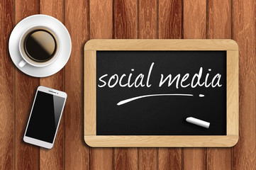 coffee, phone and chalkboard with social media words