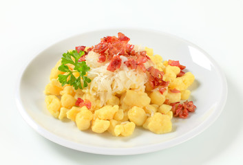 Small potato dumplings with bacon and cabbage