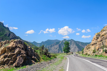 Fototapeta na wymiar Road passing through mountain valley in Altai in summer