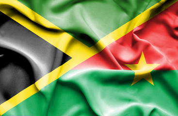 Waving flag of Burkina Faso and Jamaica