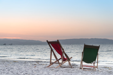 Beach chair on sand beach while beautiful sunset. Concept of rel