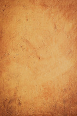Closeup detail of a ocher stone wall background.