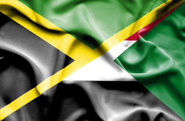 Waving flag of Sudan and Jamaica