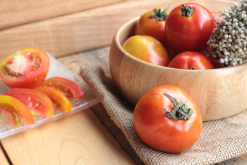 Fresh tomato on wood background